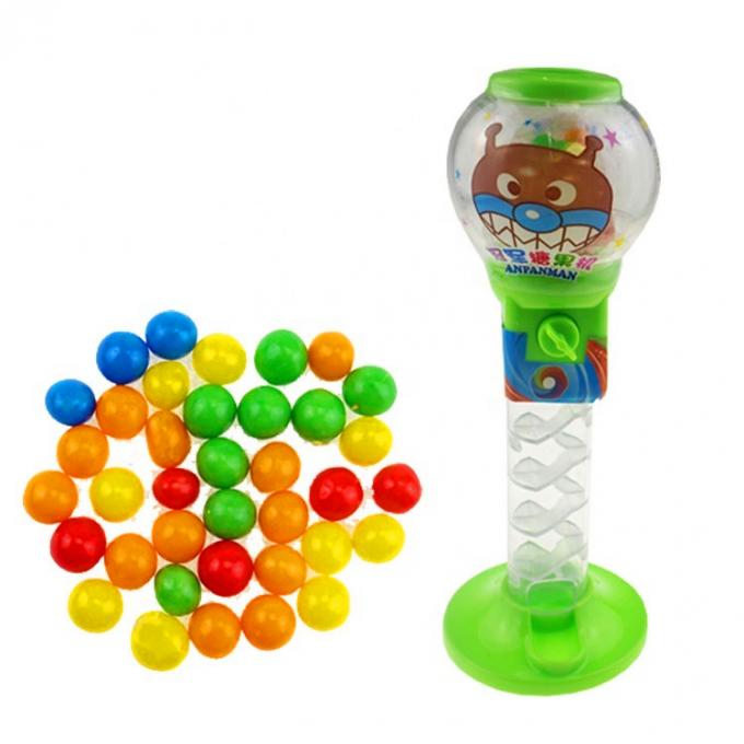 Le distributeur doux de bonbons formés par boule de jouet de sucrerie des enfants colorés de distributeur